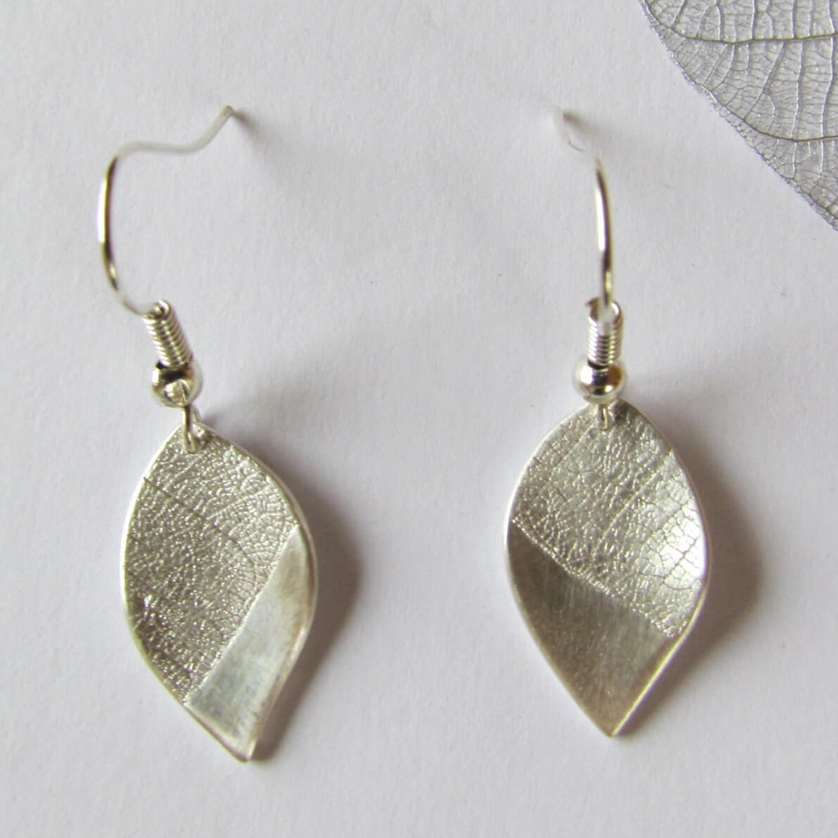 Image of Curved Silver Leaf Earrings made in the UK by Silverlines. Buying this product supports a UK business, jobs and the local community